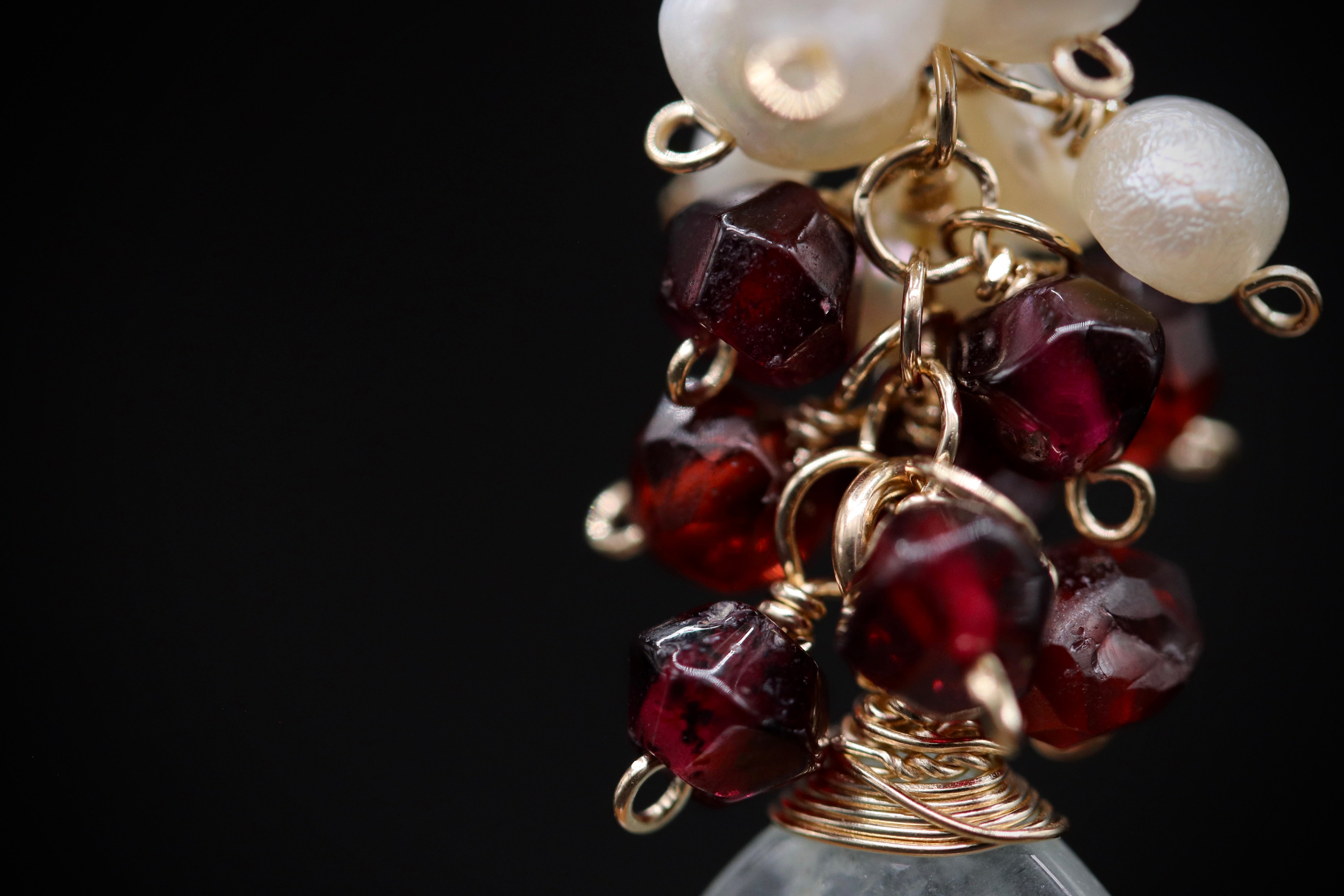 A close-up view of a decorative piece featuring a combination of red and white beads, with a metallic wire structure.