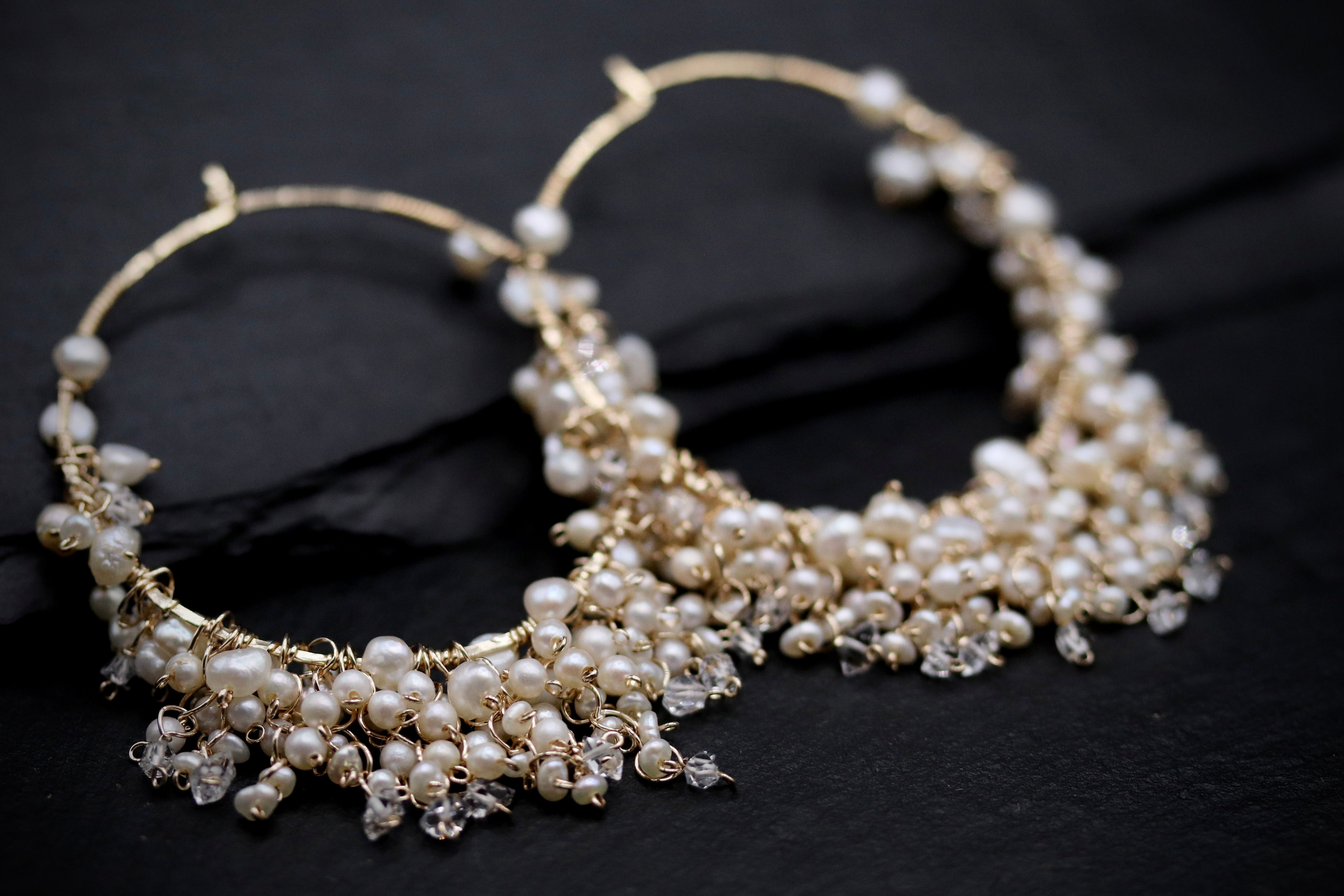 A pair of elegant earrings with a delicate design, featuring a combination of pearls and crystals.