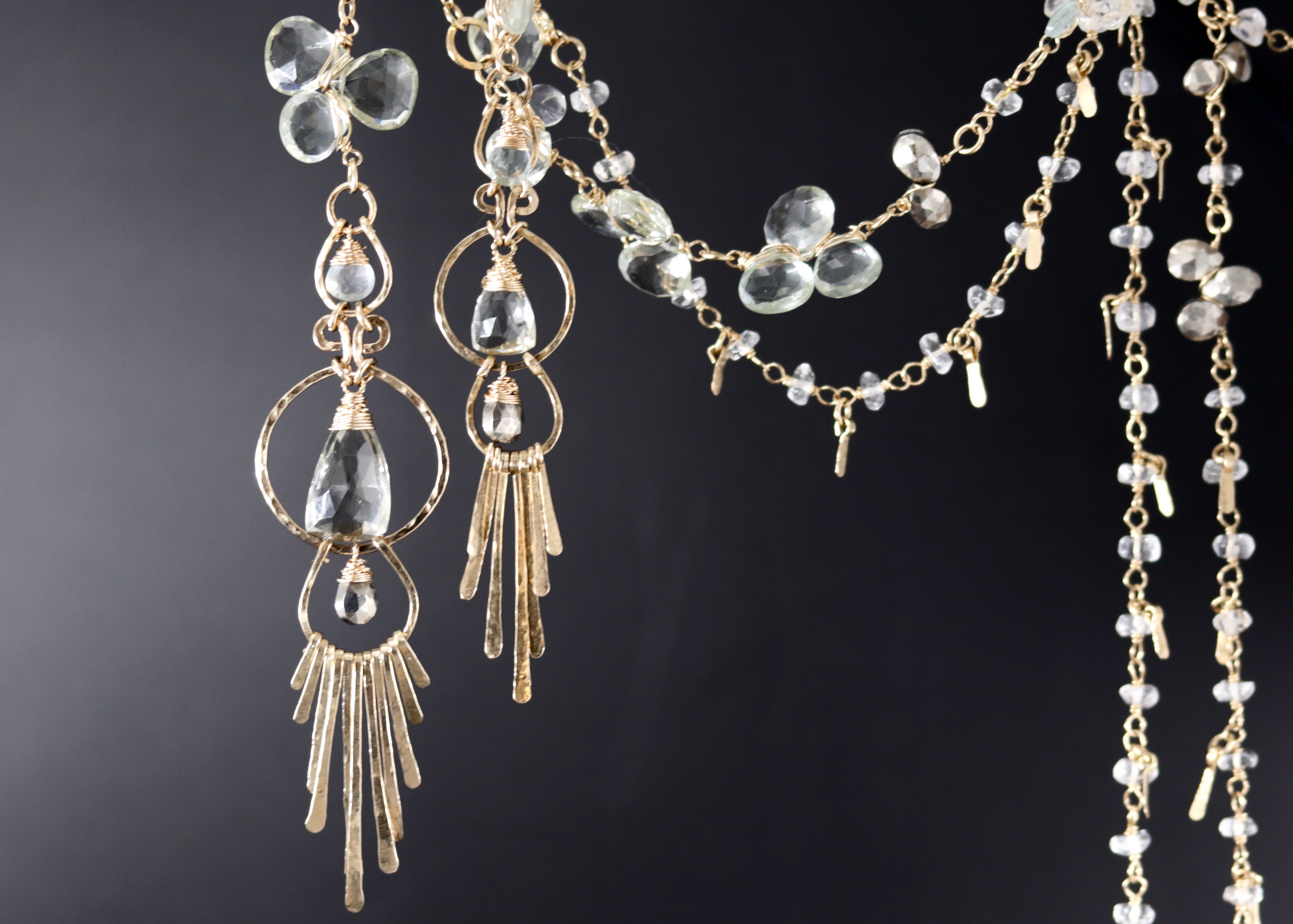 a collection of elegant jewelry, including earrings and necklaces, with a focus on the intricate designs and sparkling crystal elements.
