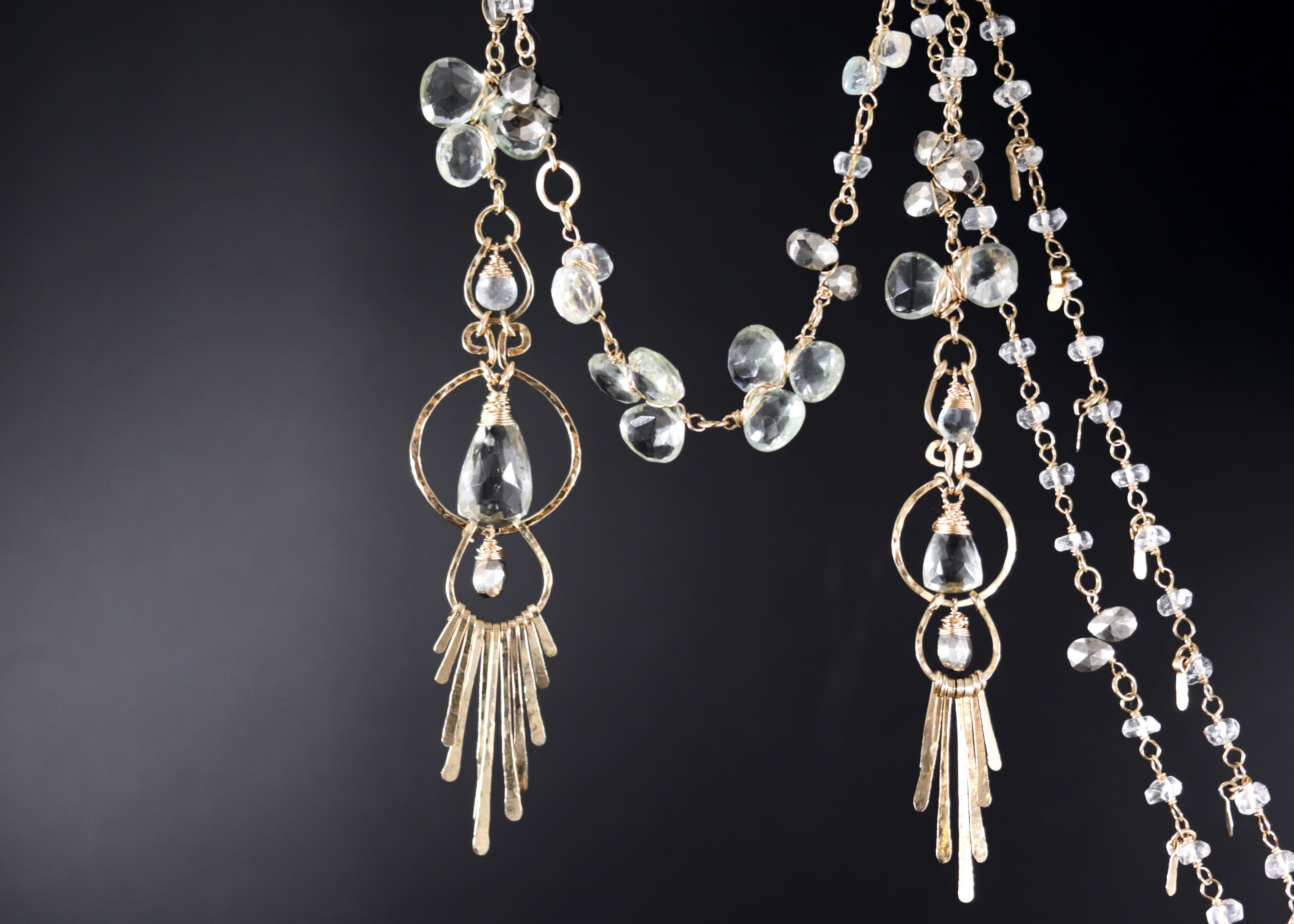 a pair of elegant, dangling earrings with clear gemstones and intricate metalwork.