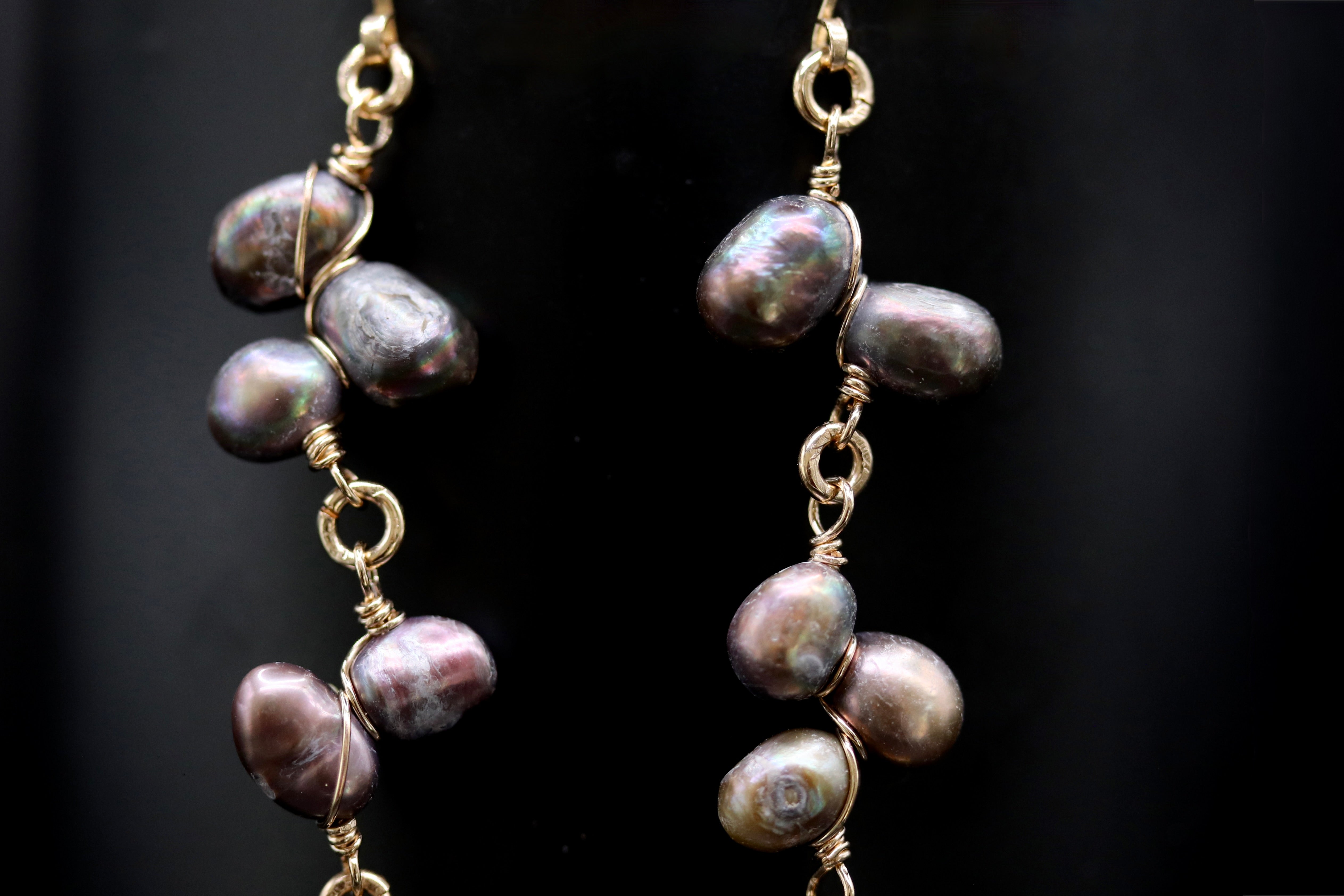 A pair of earrings with multiple strands of pearls and gold-colored metal.
